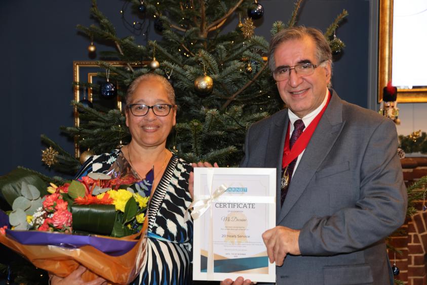 Pam Decaine receiving her award from the deputy mayor of Barnet, Cllr Tony Vourou